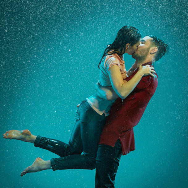 The loving couple in the rain - Фото, зображення