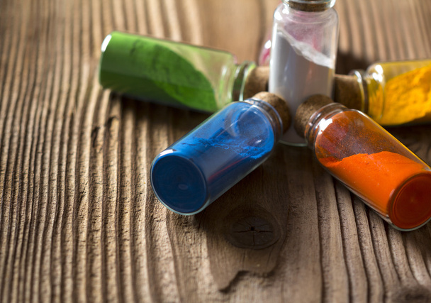Glass bottles with coloured powder - Foto, afbeelding