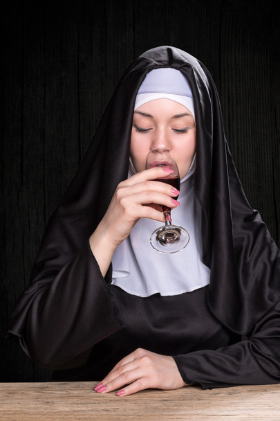 Nun drinking wine - Photo, Image