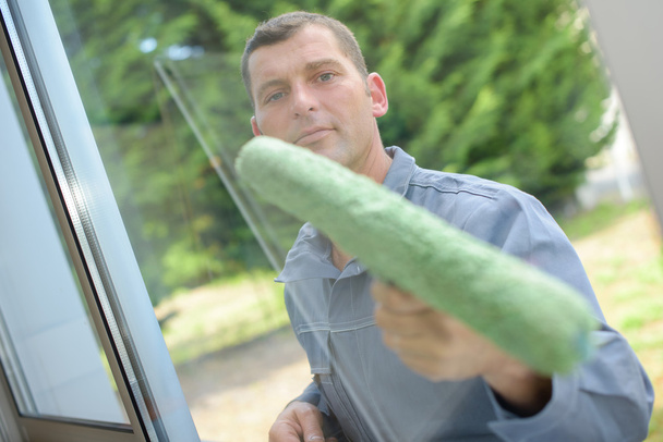 Man cleaning a window pane - Photo, Image