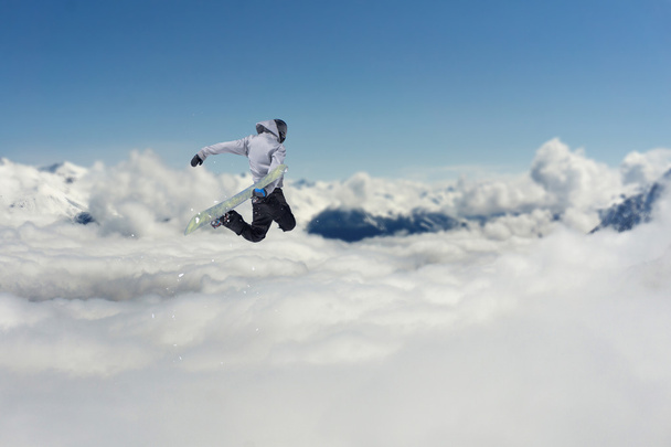 Flying snowboarder on mountains. Extreme sport. - Fotoğraf, Görsel