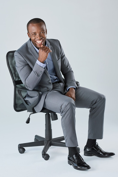 Happy smiling business man sitting in chair - Photo, image