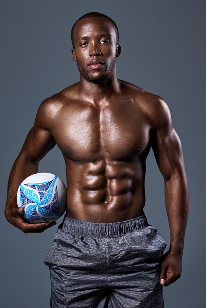serious portrait of Black african rugby player with toned muscular body - Photo, Image