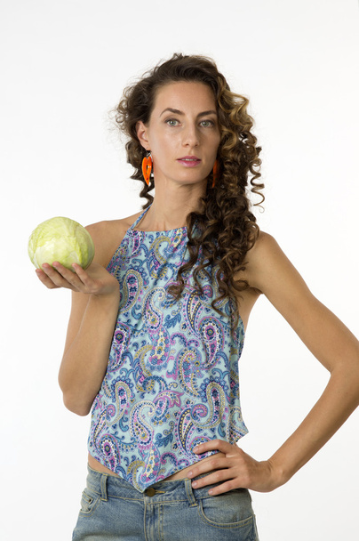 Portrait of a young beautiful woman with an cabbage in his hand - Photo, Image