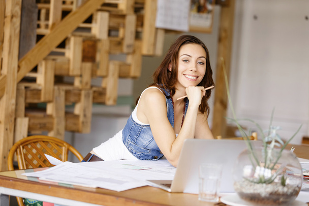 Young woman standing in creative office - Foto, afbeelding