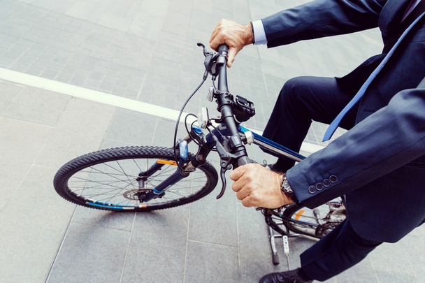 Successful businessman riding bicycle - 写真・画像