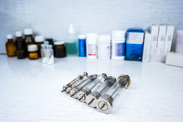 Syringe with glass vials and medications pills - Fotó, kép