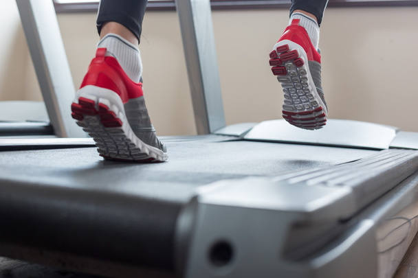 Man running in a gym on a treadmill concept for exercising, fitn - Фото, изображение