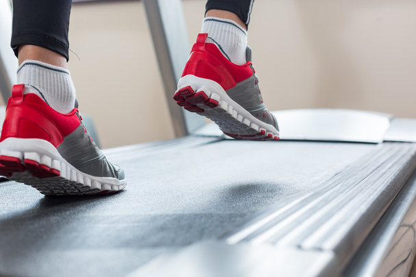 Man running in a gym on a treadmill concept for exercising, fitn - Фото, зображення