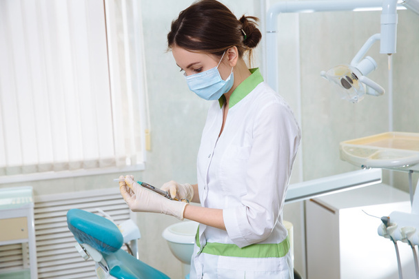 Dentists woman and a man with medical instruments in the dental office - Foto, Bild