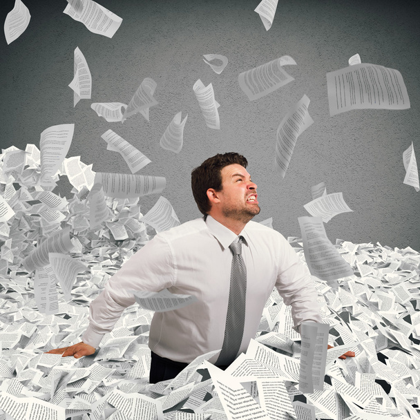 businessman goes out from a sheets pile - Photo, Image