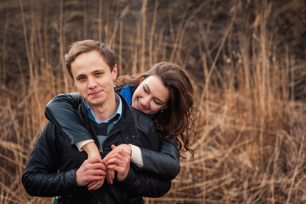  Happy couple smiling outdoors in the mountains - 写真・画像