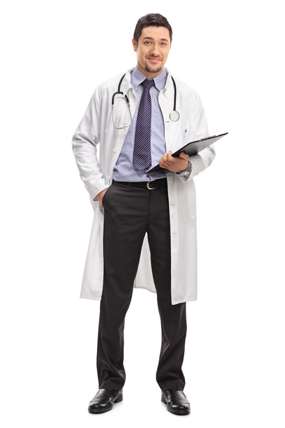 Cheerful young doctor holding a clipboard  - Foto, Imagem