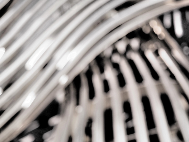 Defocussed background of a  woven steel tube pattern - Fotografie, Obrázek
