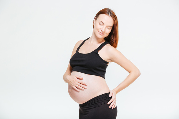 Happy pregnant woman with closed eyes - Fotoğraf, Görsel