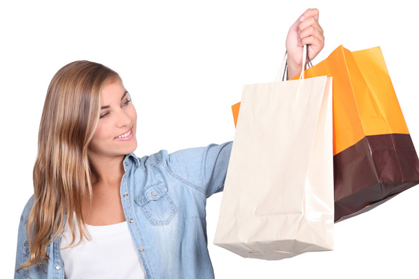 Blond teenager with shopping bags - Valokuva, kuva
