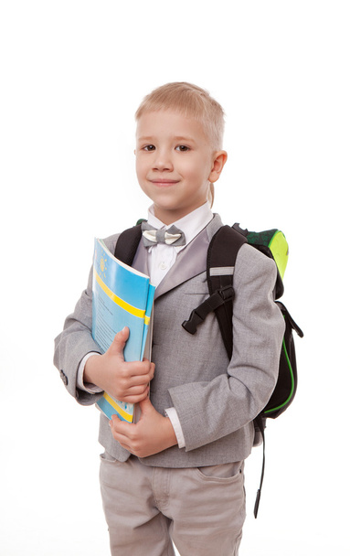 schoolboy with a backpack, a pile of books isolated on white background - Zdjęcie, obraz