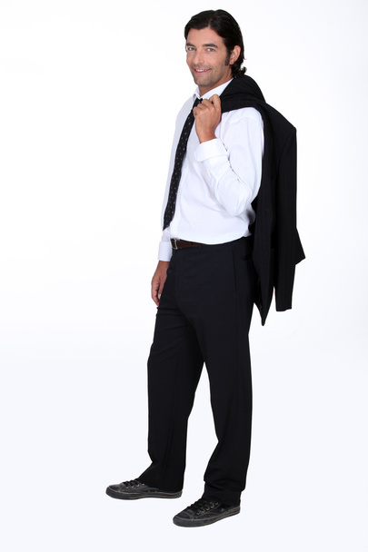 Handsome man with his suit jacket flung over his shoulder - Fotografie, Obrázek