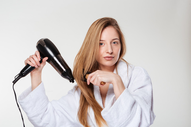 Attractive woman drying her hair - Фото, зображення