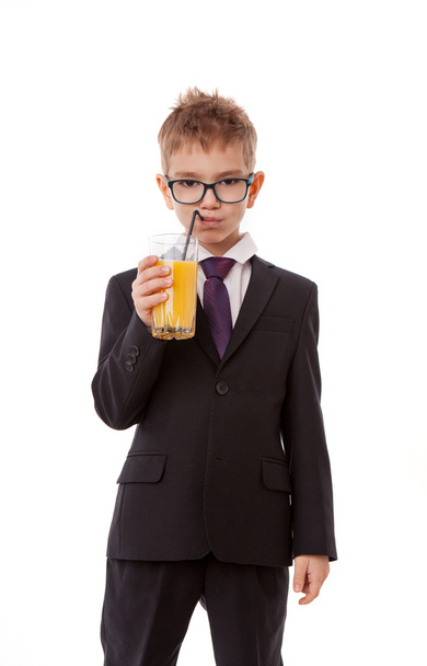 Portrait of little boy drinking orange juice. Isolated on white background. - Foto, immagini
