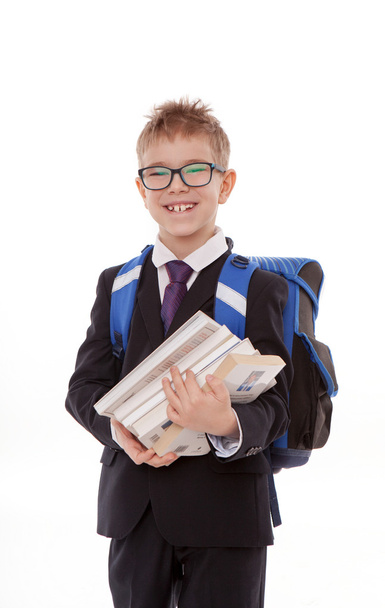 schoolboy with a backpack, a pile of books isolated on white background - Valokuva, kuva