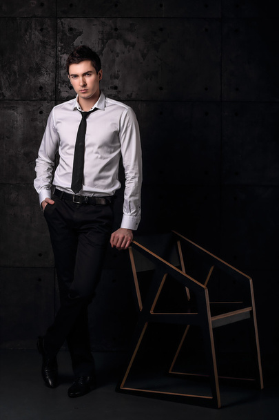 Successful businessman staing near chair - Fotoğraf, Görsel