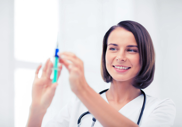 female doctor holding syringe with injection - Foto, Imagem