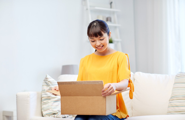 happy asian young woman with parcel box at home - Foto, immagini