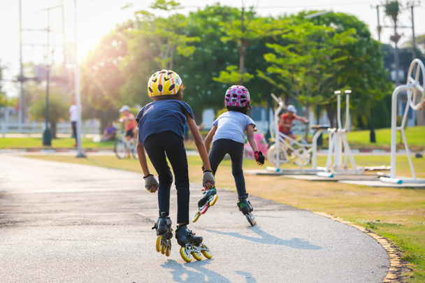 Young couples roller skates outdoor in park. - Photo, Image