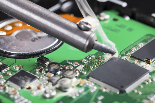 macro shot of soldering iron and circuit board - Photo, Image