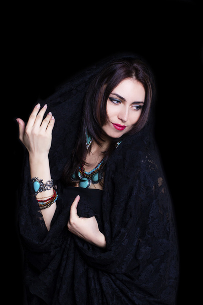 Pretty oriental woman in abaya on black background - Φωτογραφία, εικόνα