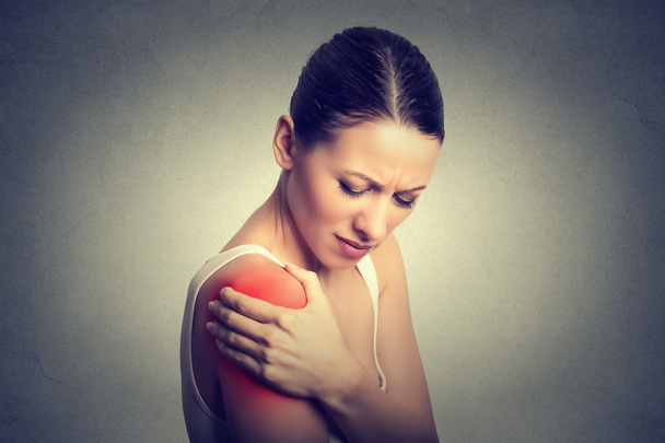 Injured joint. Woman patient in pain having painful shoulder colored in red - Fotografie, Obrázek