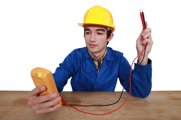 Tradesman using a multimeter - Photo, Image