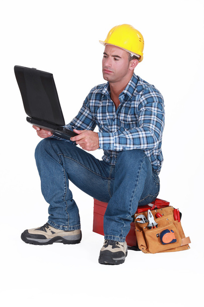 Tradesman checking his emails - 写真・画像