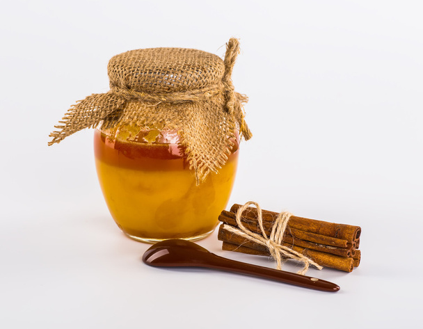 Fresh honey with nuts, lemons, still life, white background - Фото, изображение