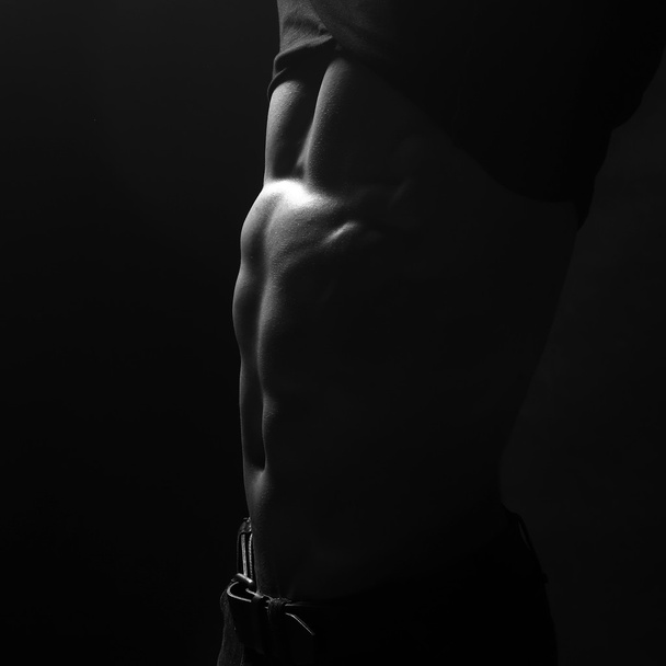 Undressing young man - 写真・画像