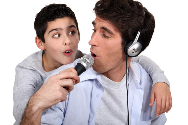 Father and son listening music and singing - Foto, afbeelding