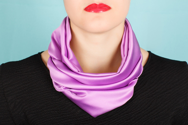 Silk scarf. Lilac silk scarf around her neck isolated on blue background.  - 写真・画像