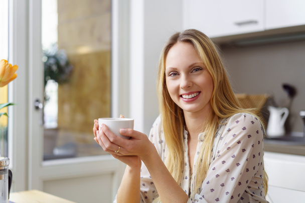 Smiling pretty woman relaxing with coffee - Fotó, kép
