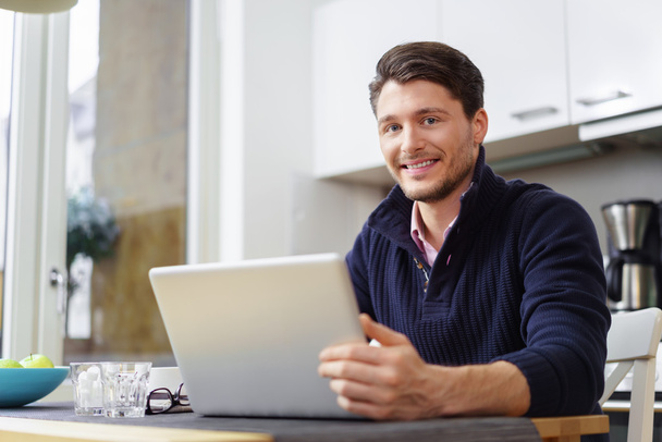 Handsome bearded man with laptop on table - Photo, image