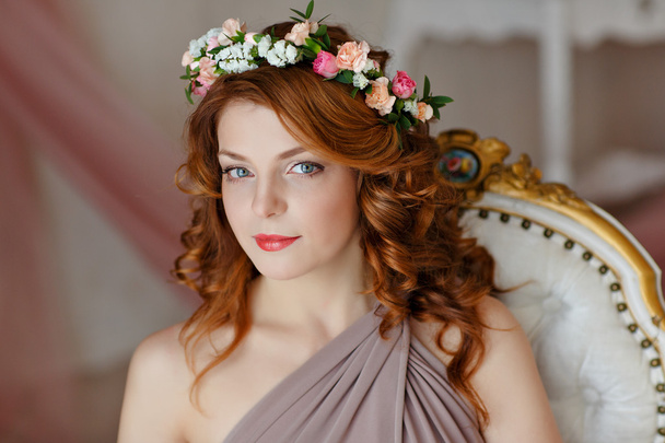 Portrait of a beautiful red-haired girl with a wreath of flowers - Фото, зображення