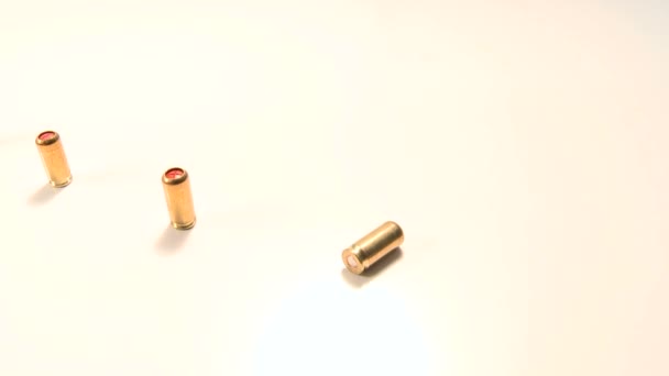 Line of pepper gas-cartridges and semi-automatic handgun,beauty-shot close-up on white background. - Footage, Video