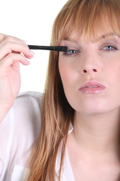 Woman applying eyeshadow - Фото, изображение