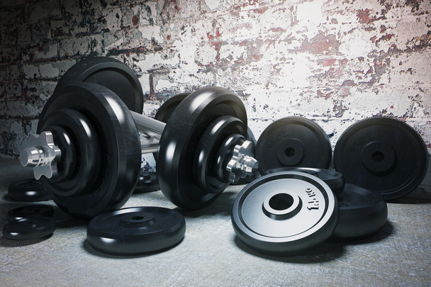 Dumbbell and plates on floor - Фото, изображение