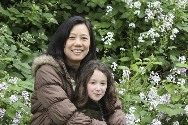 Mother and Daughter with Spring Flowers - Photo, Image