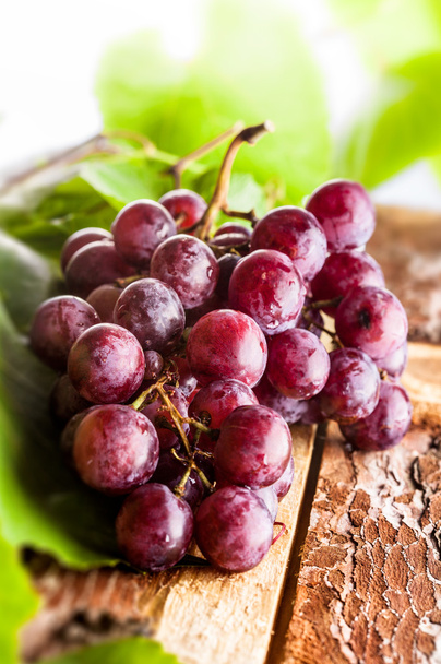 Red grapes on wooden board - Photo, Image