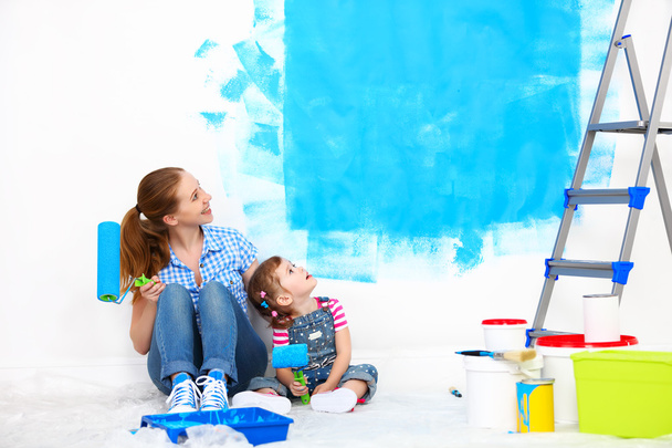happy family mother and child daughter making repairs, paint wal - Photo, Image