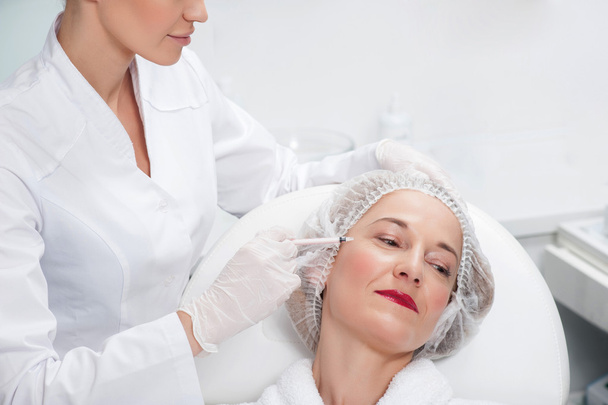 Senior lady is visiting cosmetologist to get botox - Photo, Image