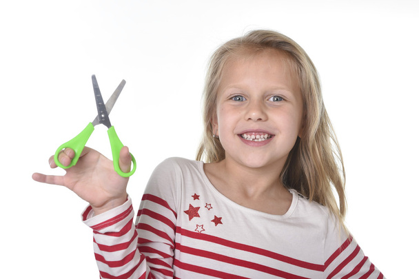 sweet beautiful female child 6 to 8 years old holding cutting sc - 写真・画像