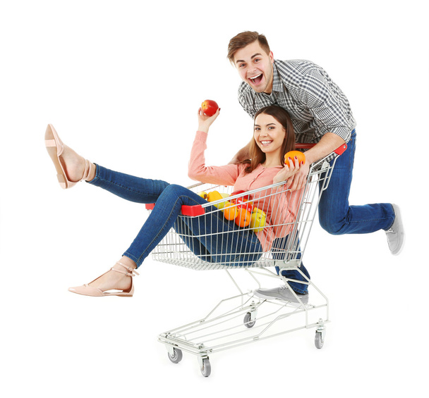 Man carrying woman in metal trolley  - Photo, Image